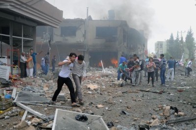 People carry injured people from one of explosion sites after several